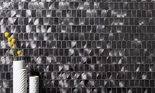 Modern bathroom with sleek black shiny tiles, adding a bold and sophisticated touch to the space. By Florida Design Works.