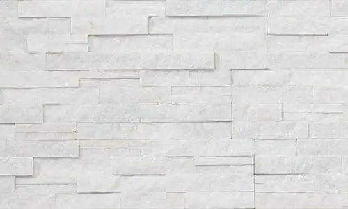 Close-up of a natural white stone surface, showcasing its elegant and textured details. By Florida Design Works.