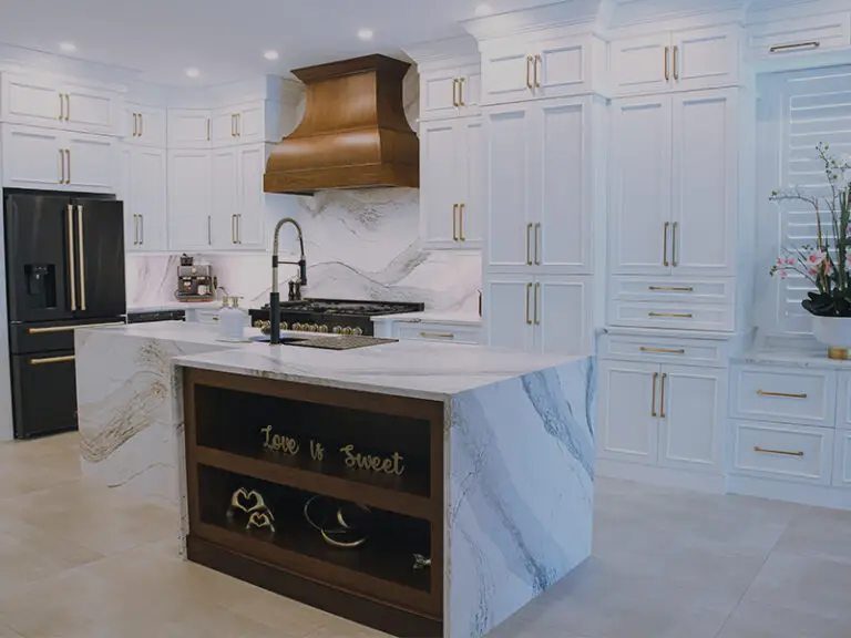 Modern kitchen with white cabinets and chrome details, designed and remodeled by Florida Design Works, showcasing a sleek and stylish aesthetic.