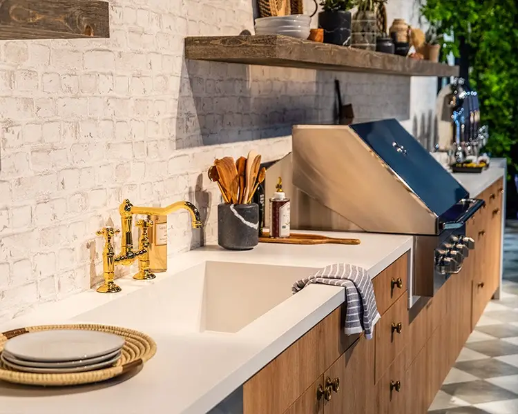 Remodeled kitchen featuring natural stone tiles and white countertops, showcasing a blend of modern design and timeless elegance. By Florida Design Works.