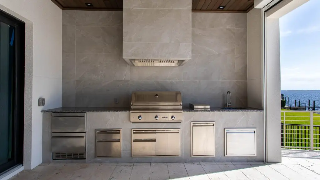 Patio with waterproof flooring, offering durability and style for outdoor spaces and outdoor kitchens adapted to Southwest Florida climate. By Florida Design Works. Florida outdoor kitchens, custom outdoor kitchens.