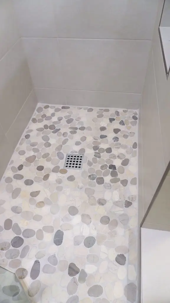 Guest bathroom walk-in shower remodel in a Longboat Key apartment, designed by Florida Design Works with clean lines and modern finishes.