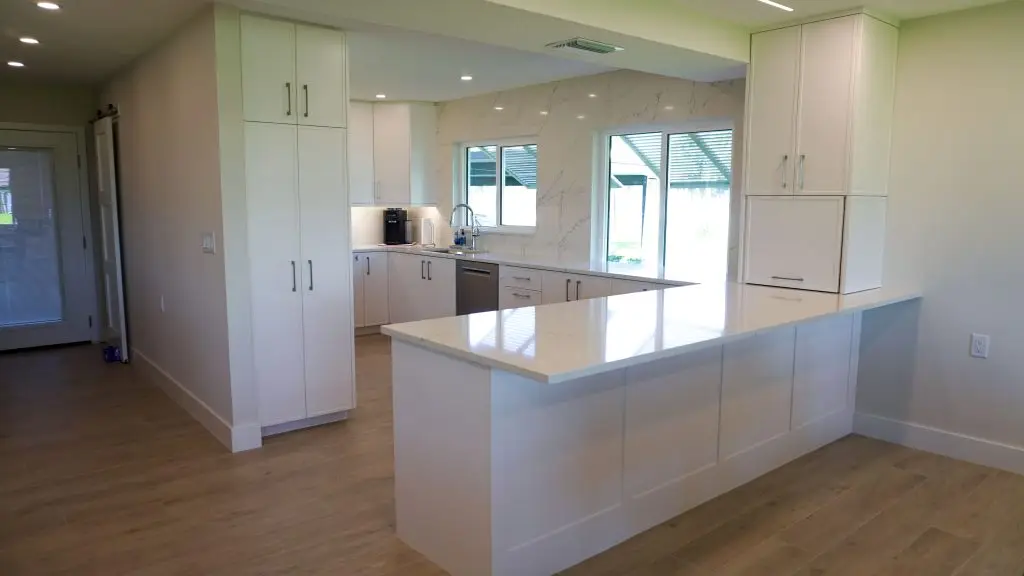 Contemporary kitchen renovation in a Longboat Key apartment, showcasing smart storage and sleek finishes by Florida Design Works.